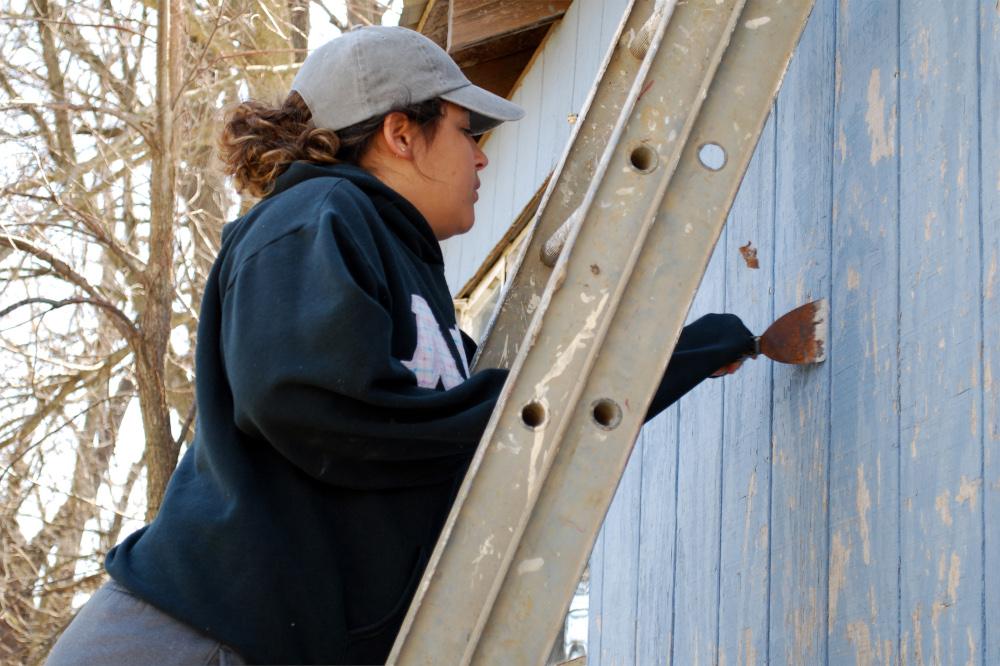 A student painting on Service Day